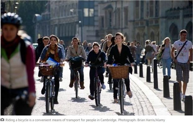 UK cambridge women cycling in streeet